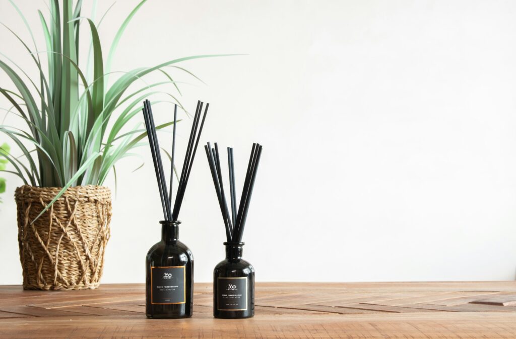 Reed diffuser sitting on a wooden table.